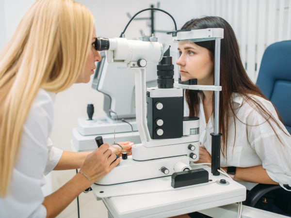 Eyesight test in optician cabinet, diagnostic of vision, professional choice of glasses lens. Patient and doctor, consultation with specialist, ophthalmology